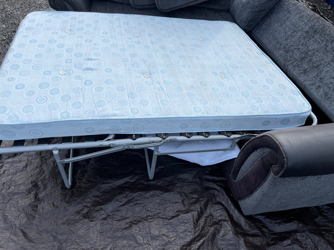Sofa bed unfolded and made up ready for sleeping